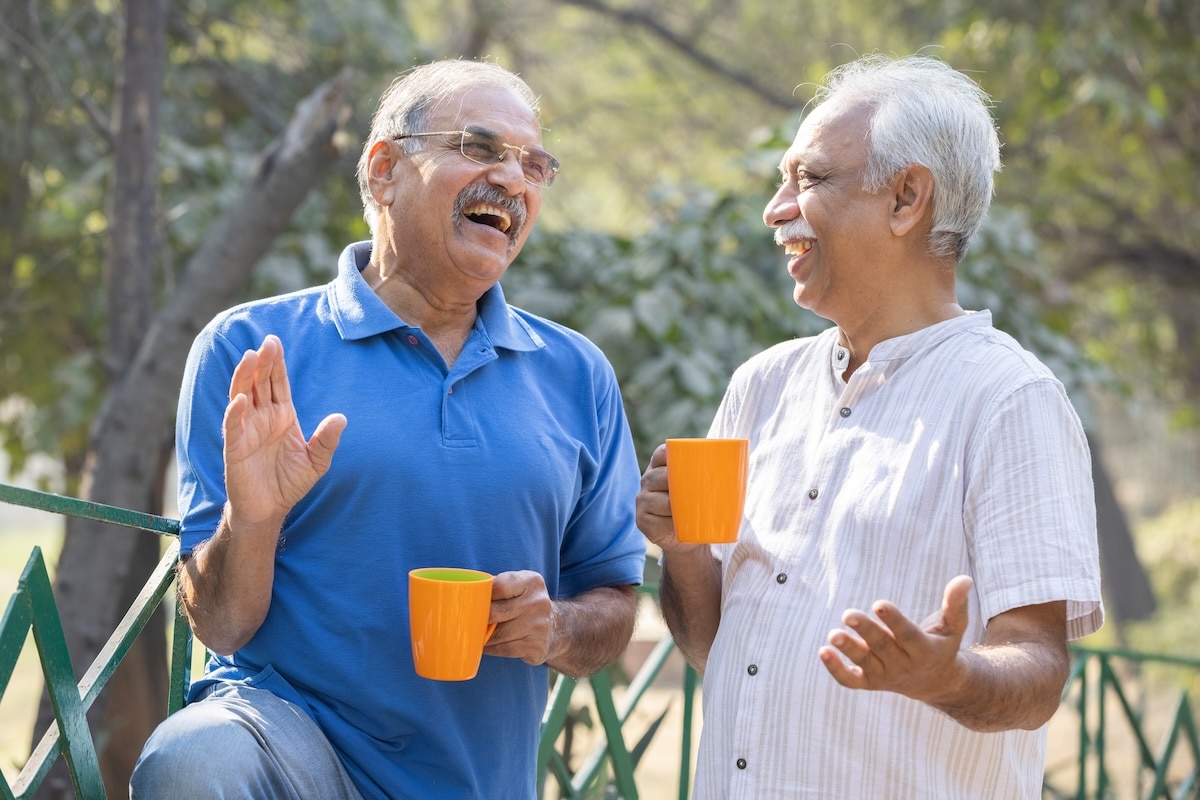 Two,Senior,Friends,Having,Fun,Raising,A,Toast,With,Coffee
